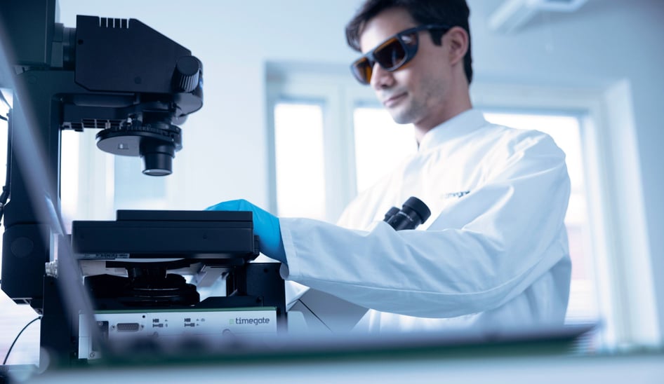 Timegate scientist operating MicroPlate HTS System with PicoRaman M3 spectrometer.